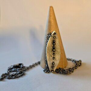 LIL LEAF NECKLACE: Silver-plated leaf pendant necklace. Brass core.